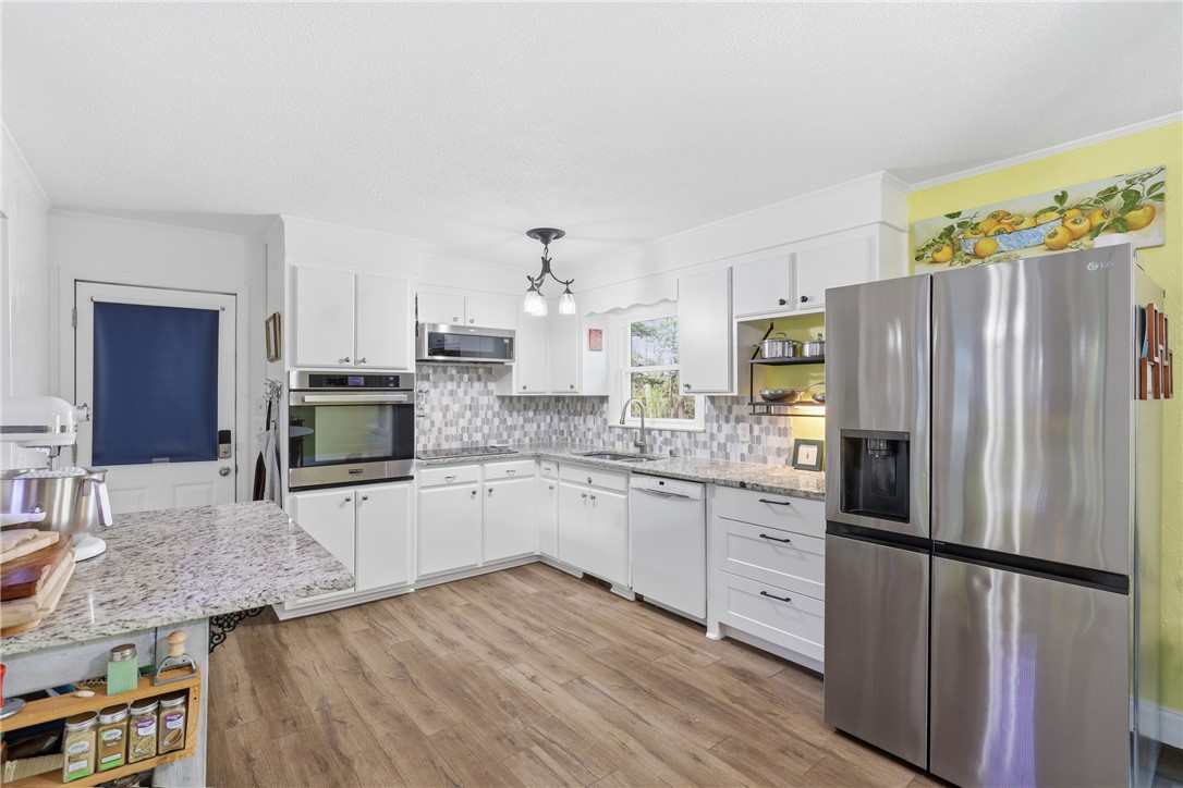 623 West Springwood Drive Seneca, SC 29672 - Photo 4 of 50 This bright, updated kitchen features granite counters, stainless steel appliances, and ample cabinetry for modern living.