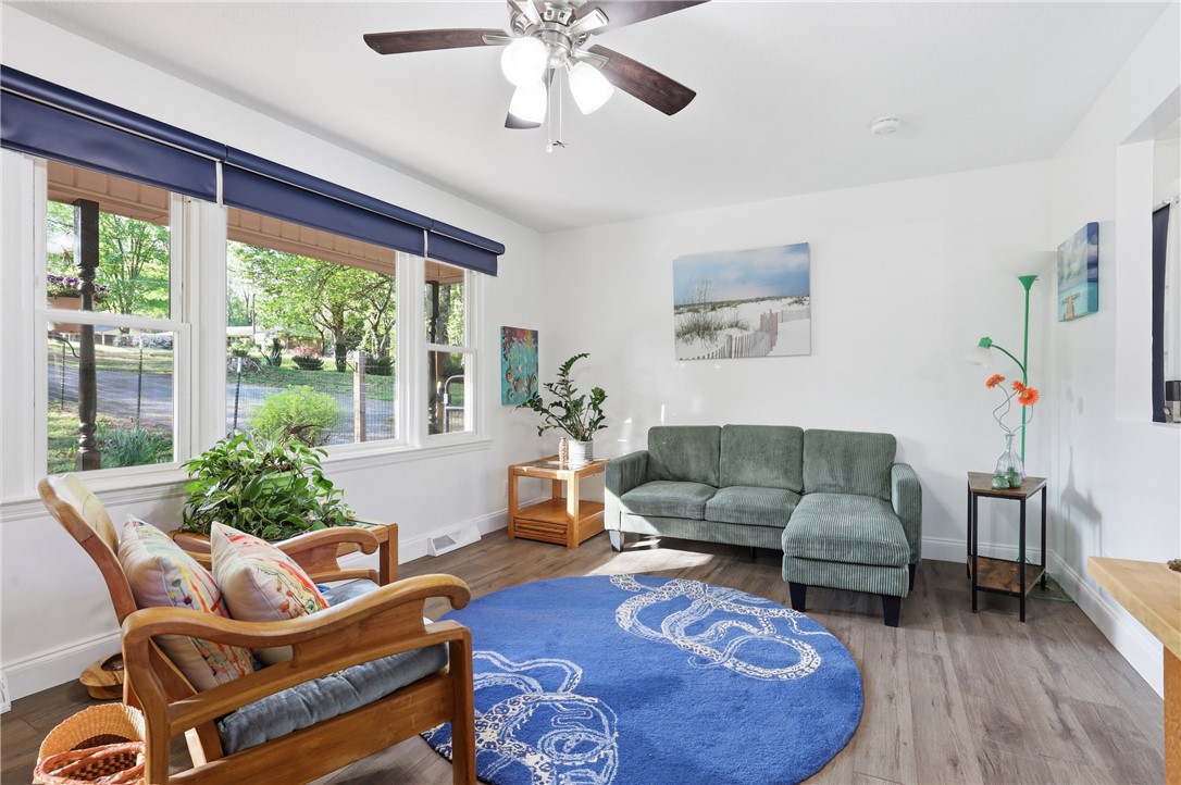 623 West Springwood Drive Seneca, SC 29672 - Photo 42 of 50 Bright and airy living room with warm flooring, large windows, and a stylish ceiling fan.