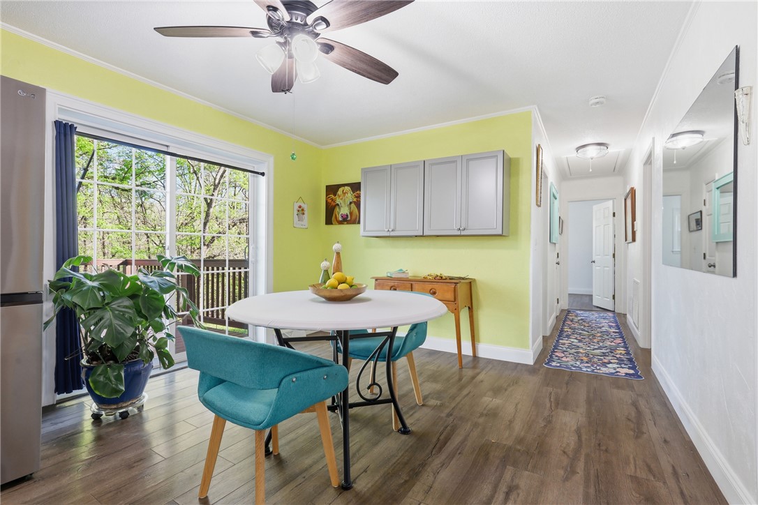 623 West Springwood Drive Seneca, SC 29672 - Photo 6 of 50 Bright dining area with wood-look flooring and easy access to an outdoor deck.