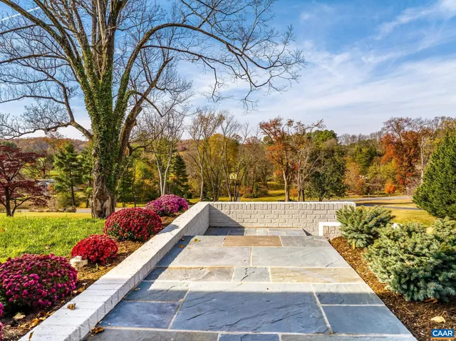 a view of empty room with wooden floor and windows