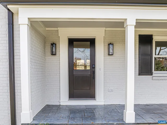 a kitchen with stainless steel appliances kitchen island granite countertop a refrigerator a oven a stove and a wooden floors