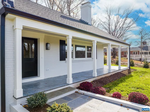 a kitchen with kitchen island a counter top space a sink stainless steel appliances and cabinets