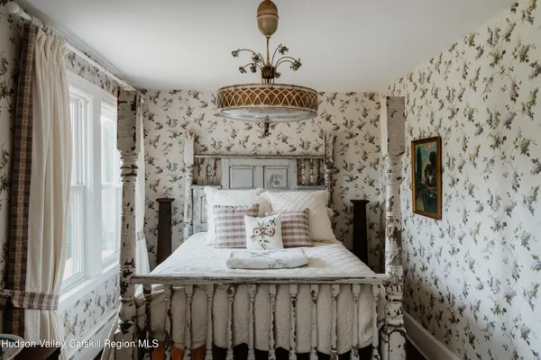 a bedroom with furniture and a window