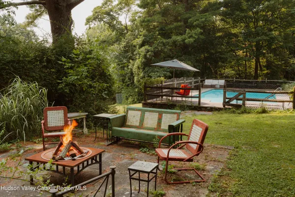 a view of a backyard with sitting area