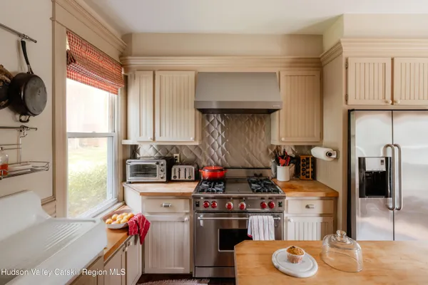 a kitchen with stainless steel appliances granite countertop a stove and a sink
