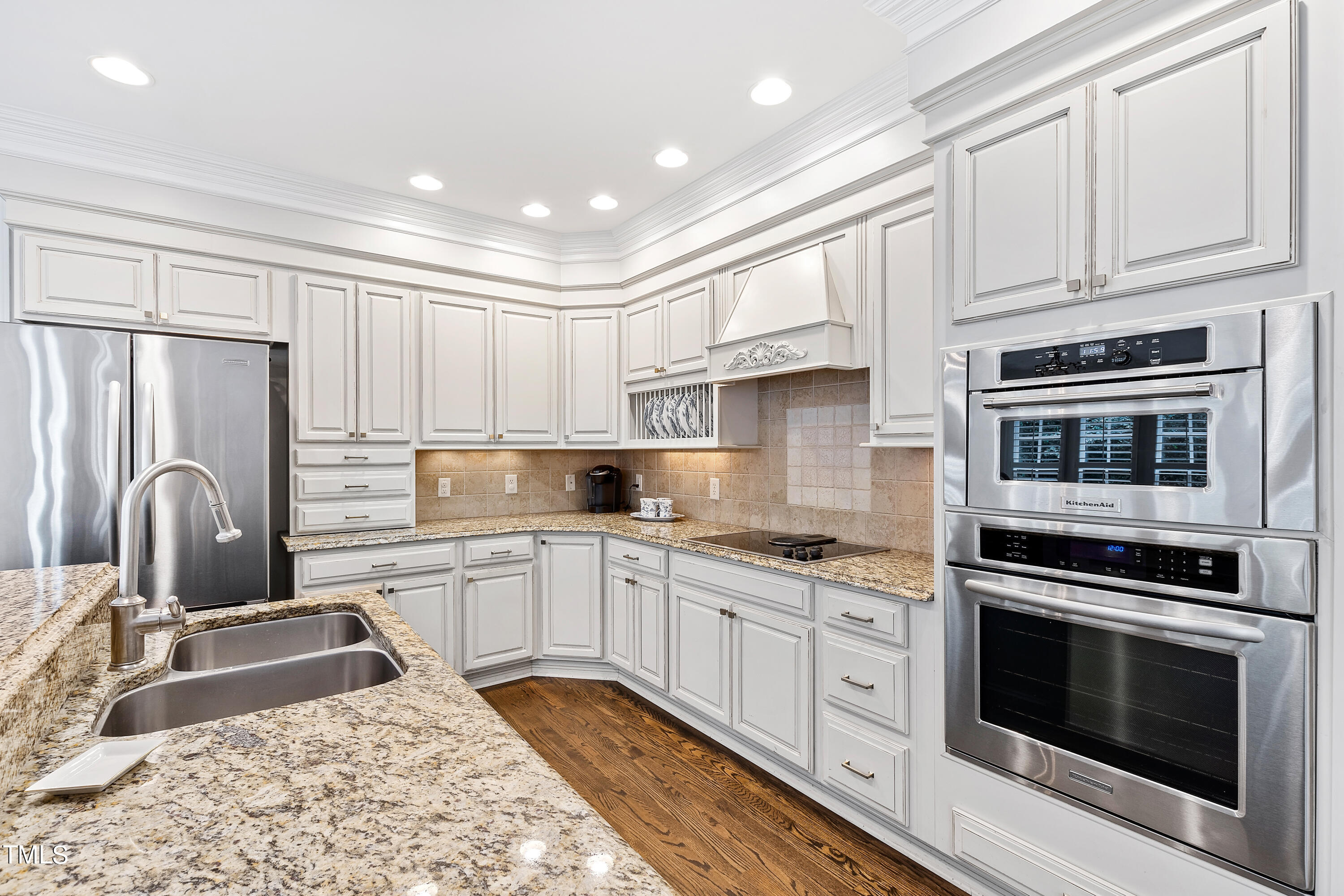 1205 Ballyhask Place Raleigh, NC 27607 - Photo 12 of 53 a kitchen with granite countertop a stove sink and refrigerator