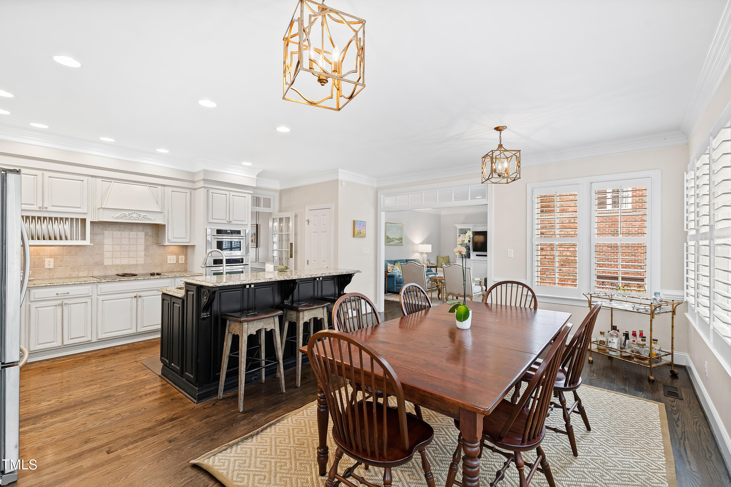 1205 Ballyhask Place Raleigh, NC 27607 - Photo 10 of 53 a view of a dining room with furniture window and wooden floor