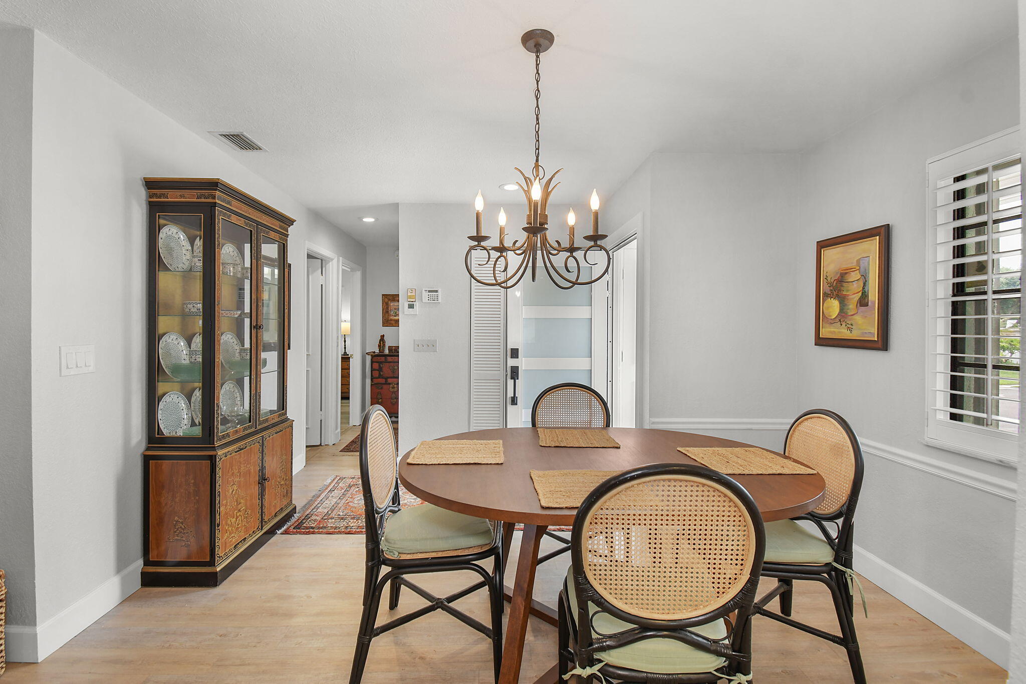 5251 Southeast Sea Island Way Stuart, FL 34997 - Photo 6 of 68 a dining room with furniture a chandelier and wooden floor