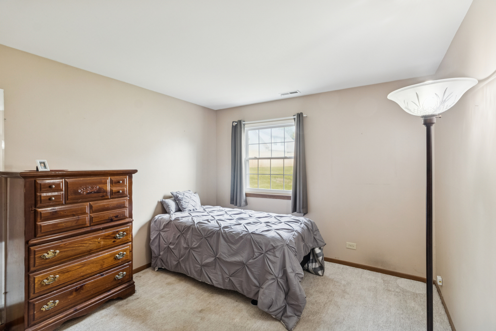 66 Gant Circle, Unit D Streamwood, IL 60107 - Photo 13 of 13 a bedroom with a bed and a closet