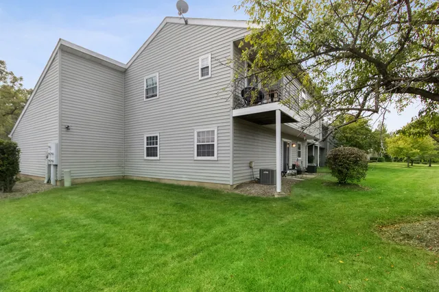a backyard of a house with table and chairs