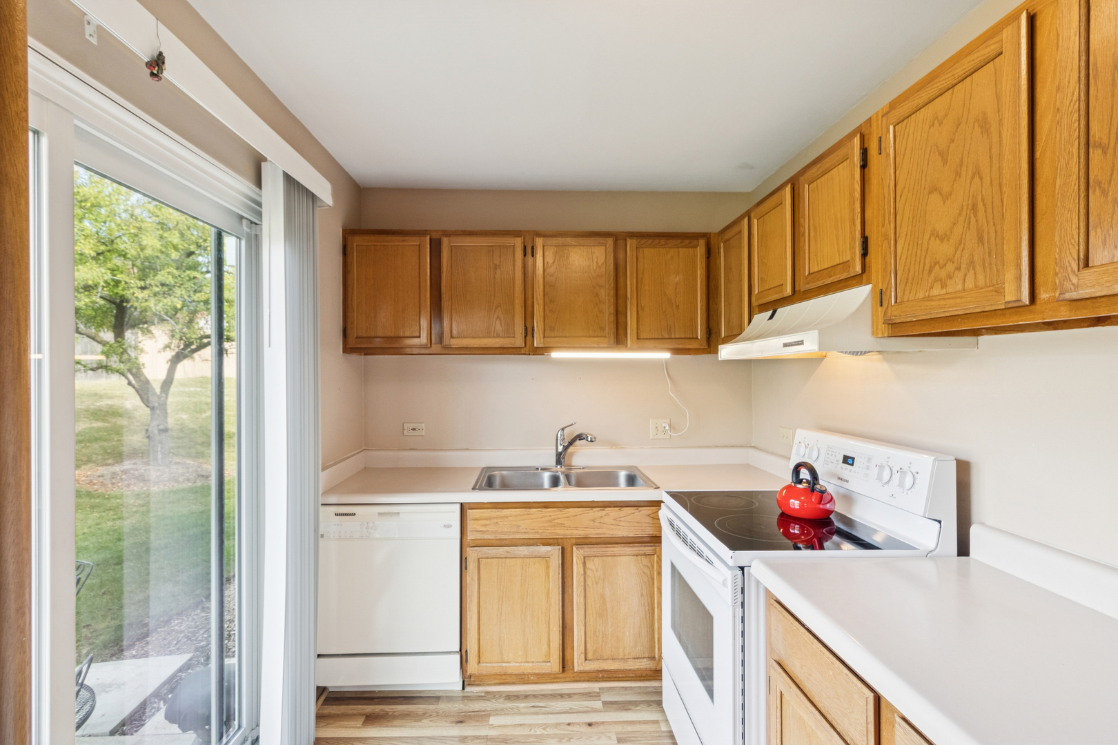 66 Gant Circle, Unit D Streamwood, IL 60107 - Photo 7 of 13 a kitchen with a sink cabinets and a window