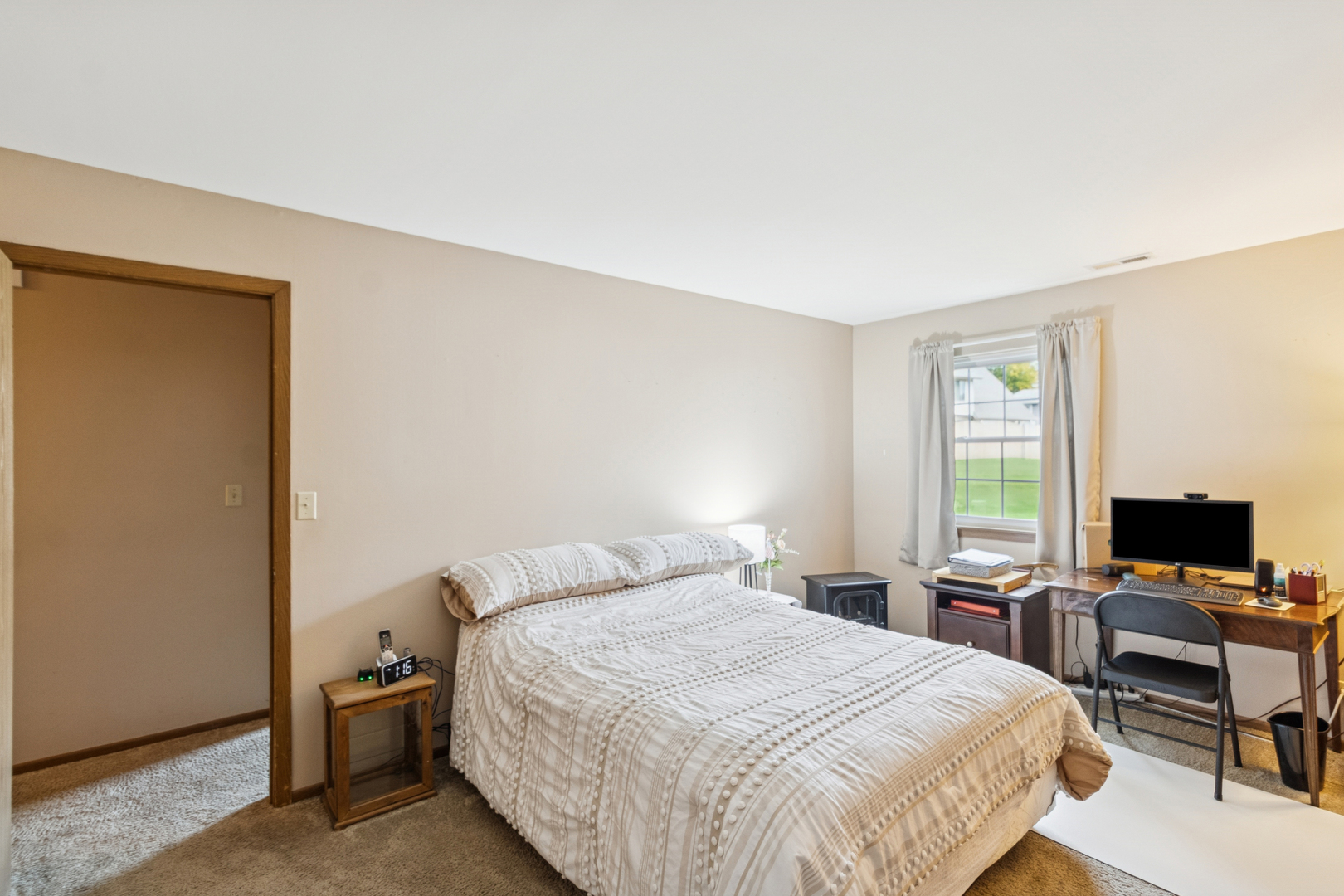 66 Gant Circle, Unit D Streamwood, IL 60107 - Photo 10 of 13 a bedroom with a bed and a flat screen tv