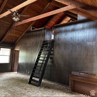 4709 East Independence Road Myton, UT 84052 - Photo 12 of 27 Stairway featuring a wood ceiling with exposed beams, wood walls, ceiling fan, and high vaulted ceiling