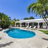 swimming pool view with a seating space