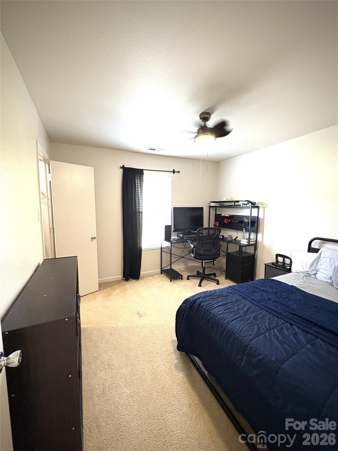 2514 Spring Breeze Way Monroe, NC 28110 - Photo 20 of 25 a bedroom with a bed and dresser with mirror