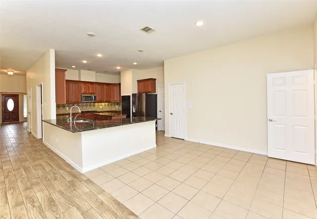 a view of large kitchen with stainless steel appliances cabinets