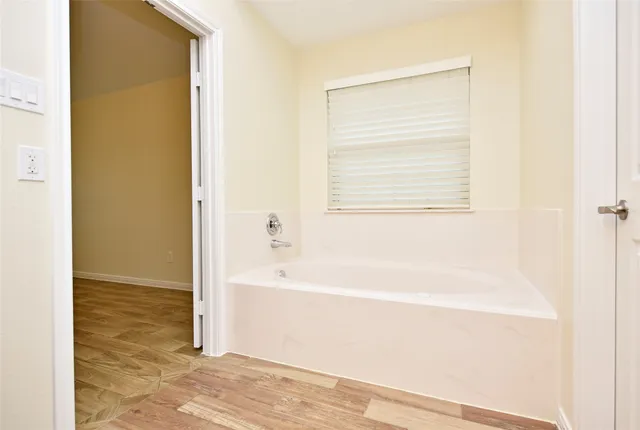 a bathroom with a bathtub and a shower