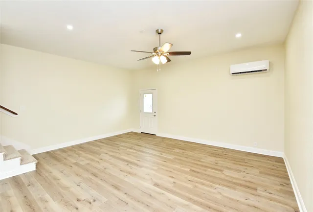 a view of a kitchen with a sink and a ceiling fan