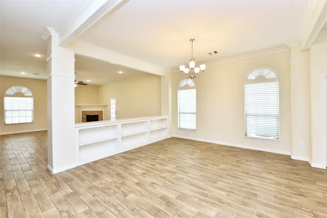 wooden floor in an empty room with a window
