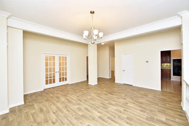 a view of an empty room with wooden floor