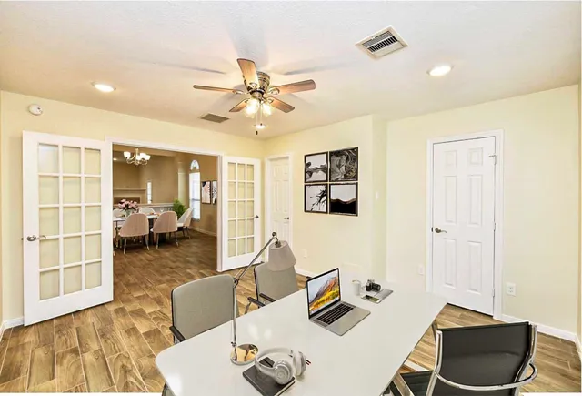 a living room with furniture and wooden floor