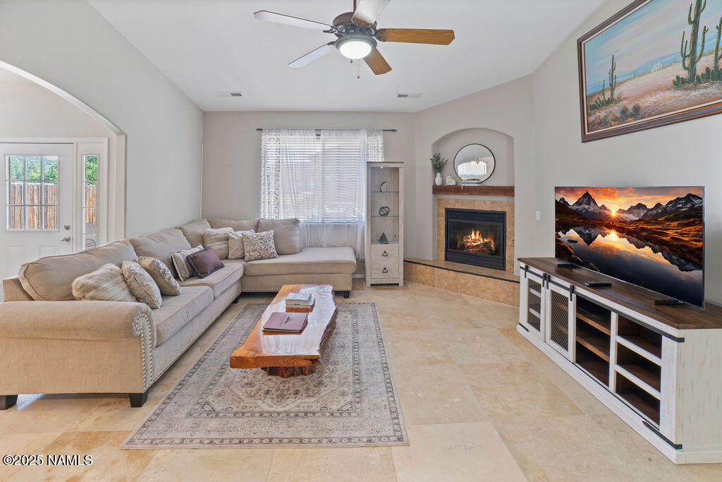 603 Brookline Loop Williams, AZ 86046 - Photo 14 of 57 a living room with furniture a fireplace and a flat screen tv