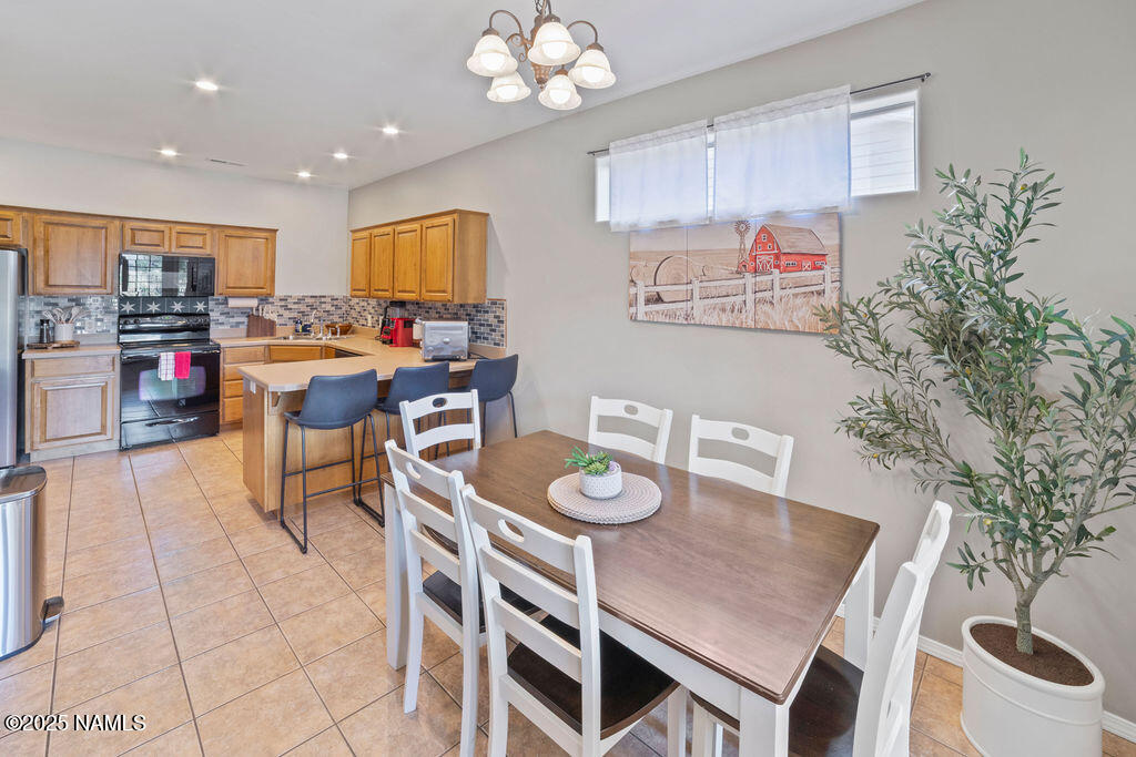 603 Brookline Loop Williams, AZ 86046 - Photo 21 of 57 a view of a dining room with furniture and a kitchen