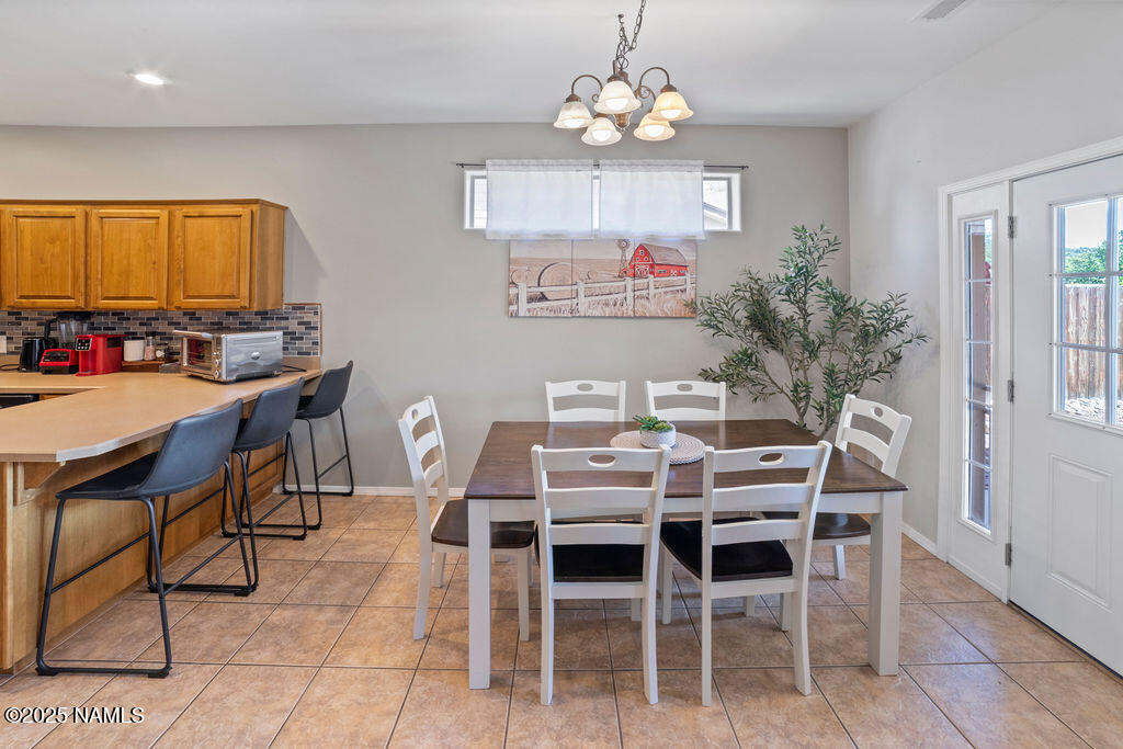 603 Brookline Loop Williams, AZ 86046 - Photo 22 of 57 a view of a dining room with furniture window and wooden floor