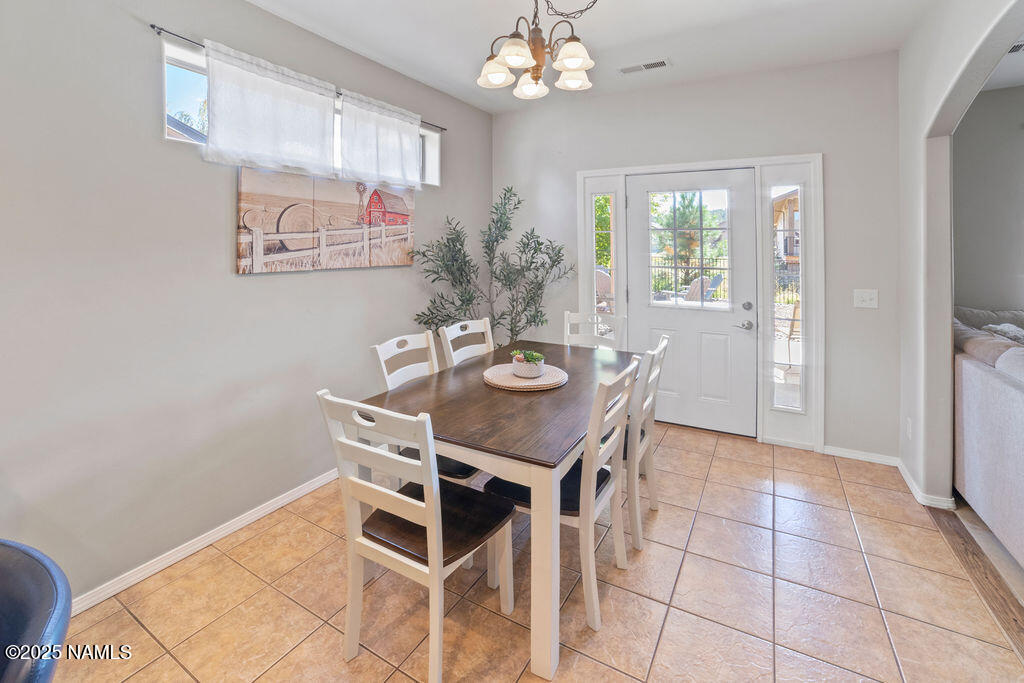 603 Brookline Loop Williams, AZ 86046 - Photo 23 of 57 a view of a dining room with furniture and chandelier