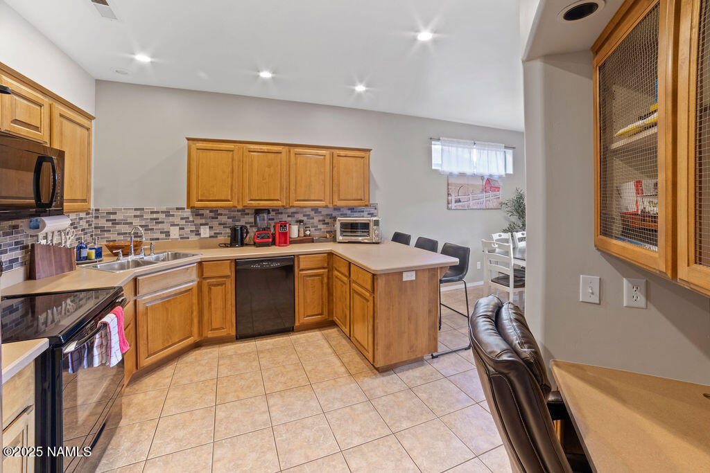 603 Brookline Loop Williams, AZ 86046 - Photo 24 of 57 a kitchen with a sink stove and cabinets