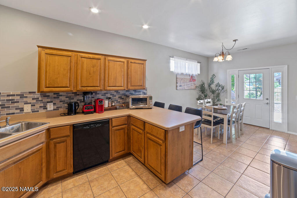 603 Brookline Loop Williams, AZ 86046 - Photo 27 of 57 a kitchen that has a sink a table and chairs in it
