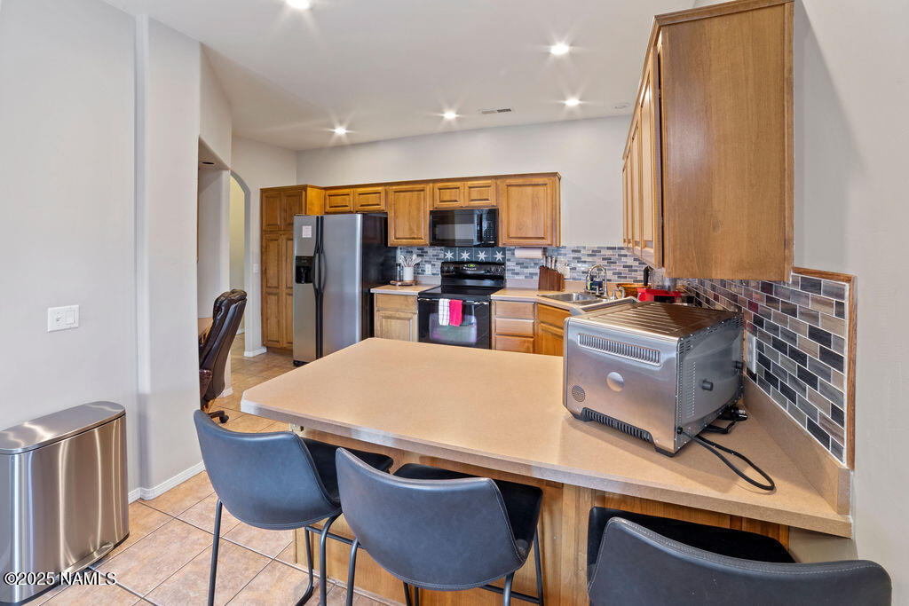 603 Brookline Loop Williams, AZ 86046 - Photo 28 of 57 a living room with stainless steel appliances furniture a rug and a kitchen view