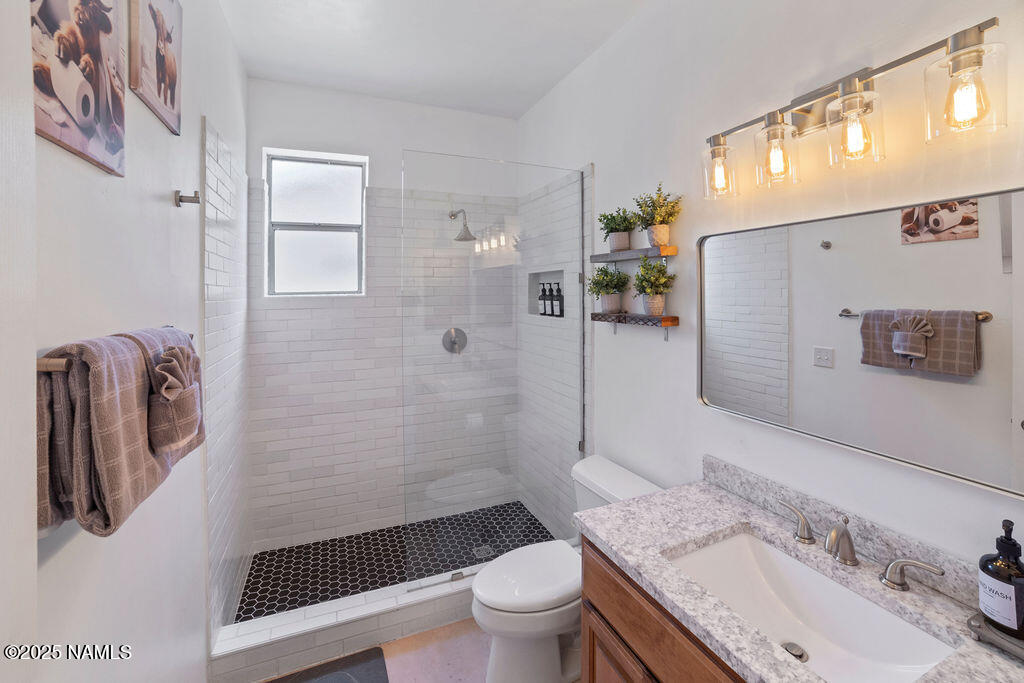 603 Brookline Loop Williams, AZ 86046 - Photo 30 of 57 a bathroom with a sink a toilet and shower