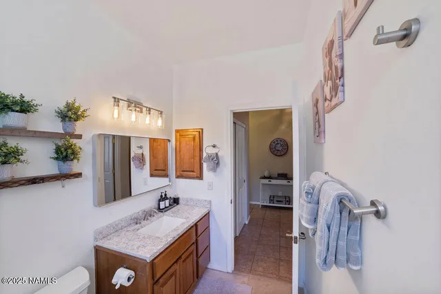 a bedroom with bed and wooden floor