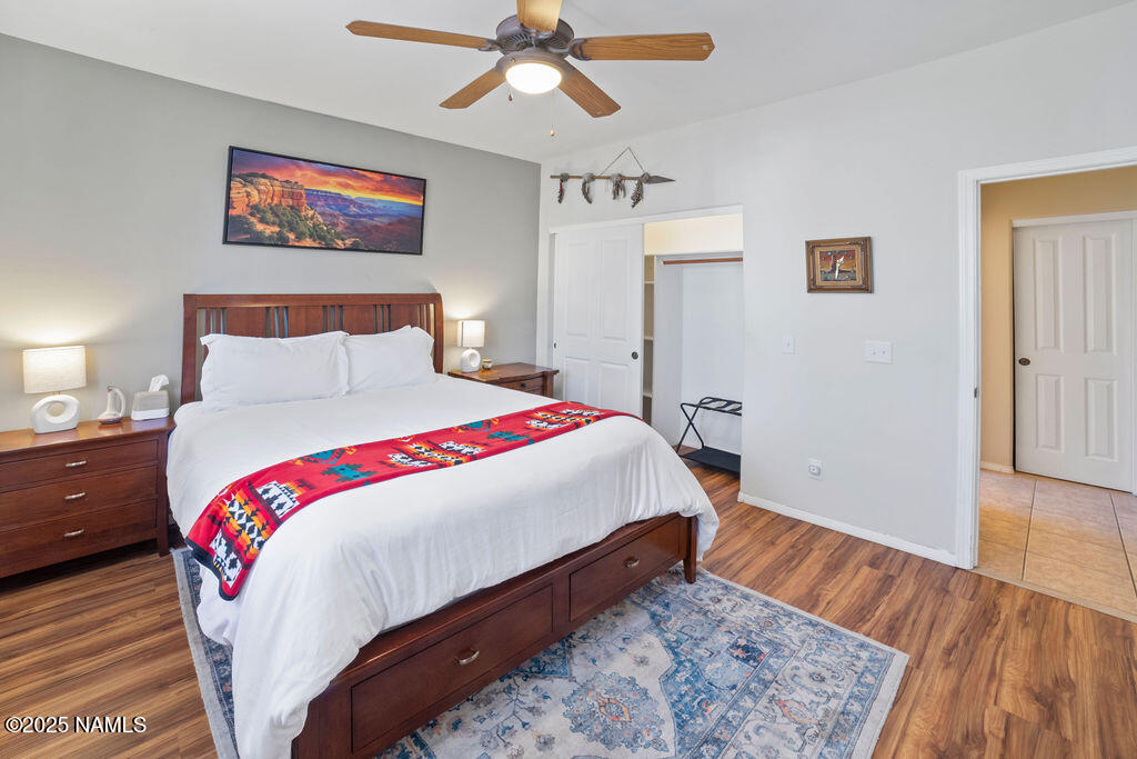 603 Brookline Loop Williams, AZ 86046 - Photo 34 of 57 a bedroom with bed and wooden floor
