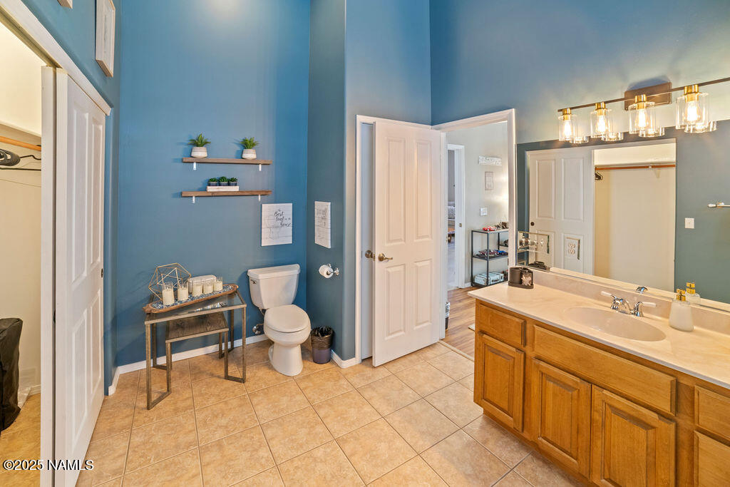 603 Brookline Loop Williams, AZ 86046 - Photo 41 of 57 a bathroom with a sink a toilet and a mirror