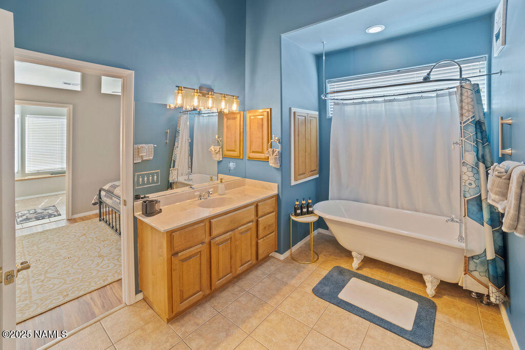 603 Brookline Loop Williams, AZ 86046 - Photo 42 of 57 a bathroom with a tub sink and mirror