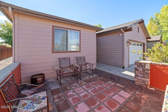 a backyard of a house with outdoor seating