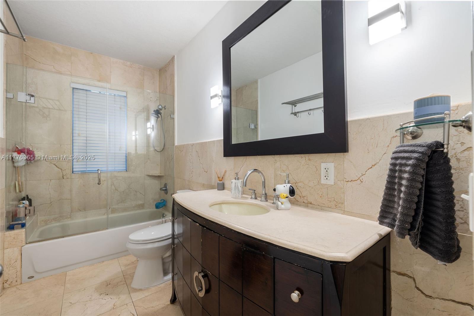 411 Southwest 22nd Road Miami, FL 33129 - Photo 14 of 25 a bathroom with a sink a toilet and shower