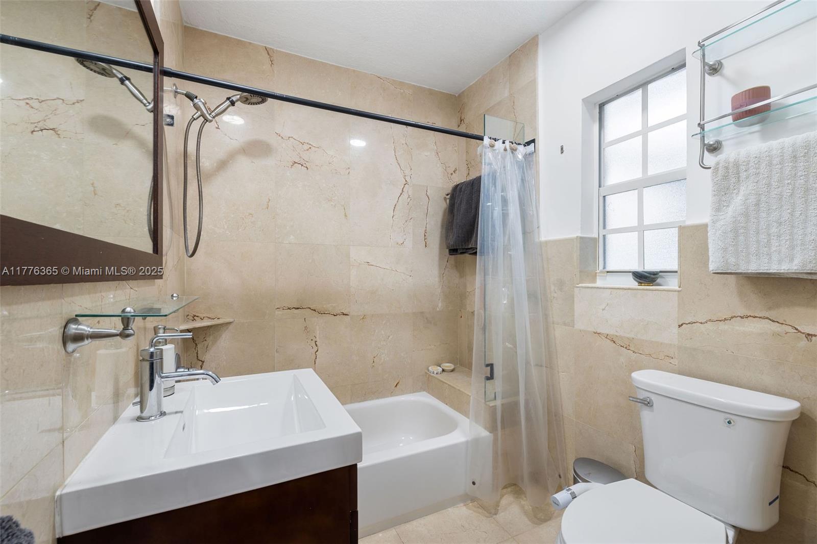 411 Southwest 22nd Road Miami, FL 33129 - Photo 16 of 25 a bathroom with a sink toilet and shower