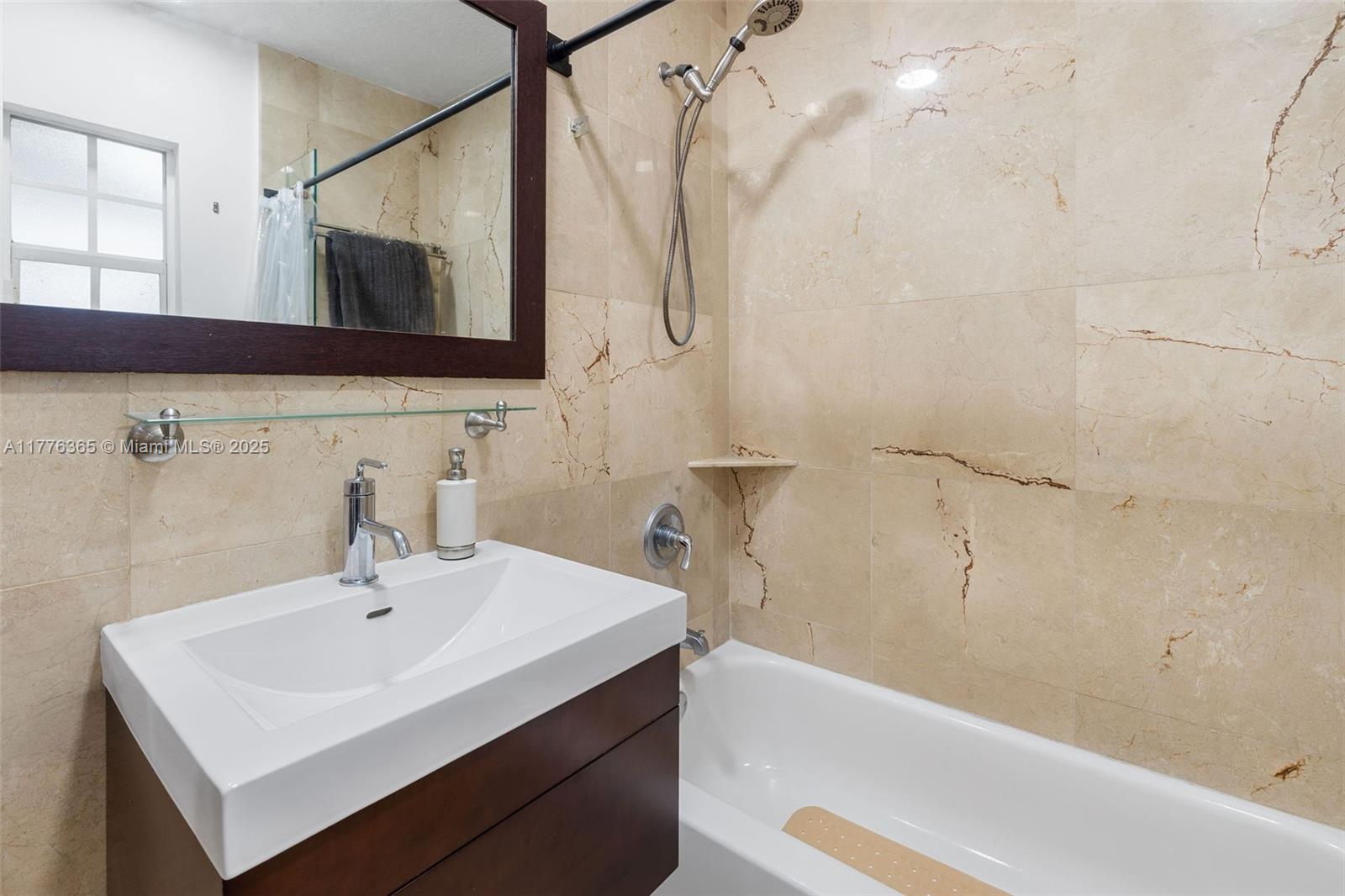 411 Southwest 22nd Road Miami, FL 33129 - Photo 17 of 25 a bathroom with a sink and a mirror