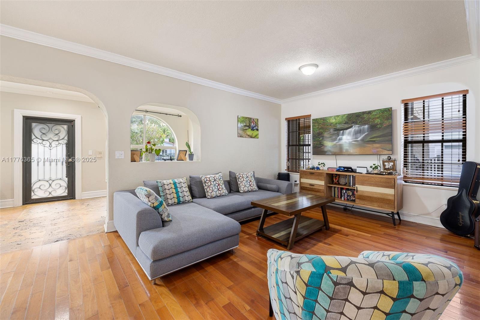 411 Southwest 22nd Road Miami, FL 33129 - Photo 5 of 25 a living room with furniture and a floor to ceiling window