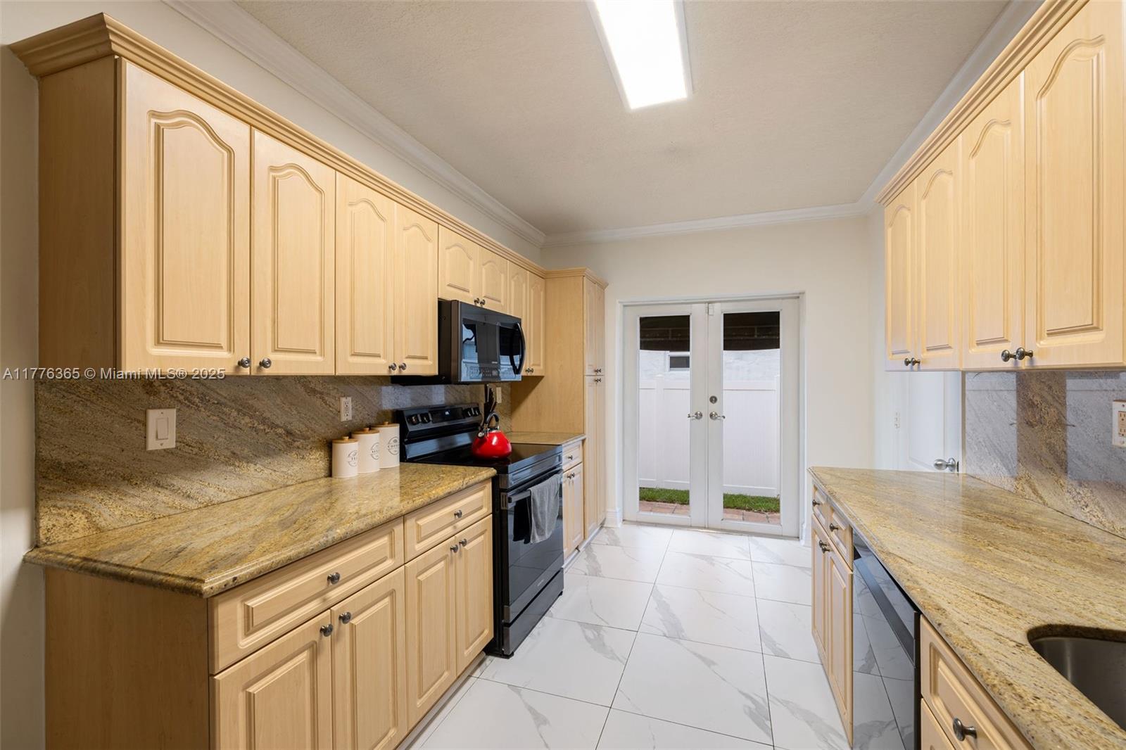 411 Southwest 22nd Road Miami, FL 33129 - Photo 10 of 25 a kitchen with a stove a sink and a refrigerator
