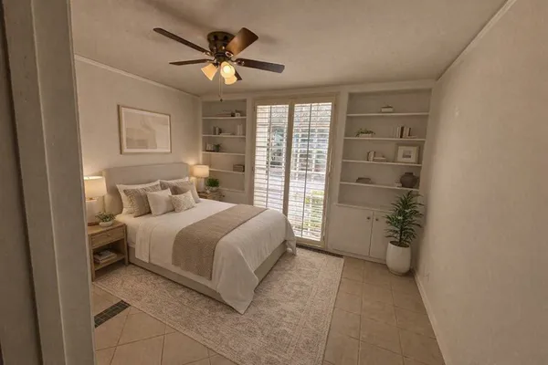 a spacious bedroom with a bed and a chandelier