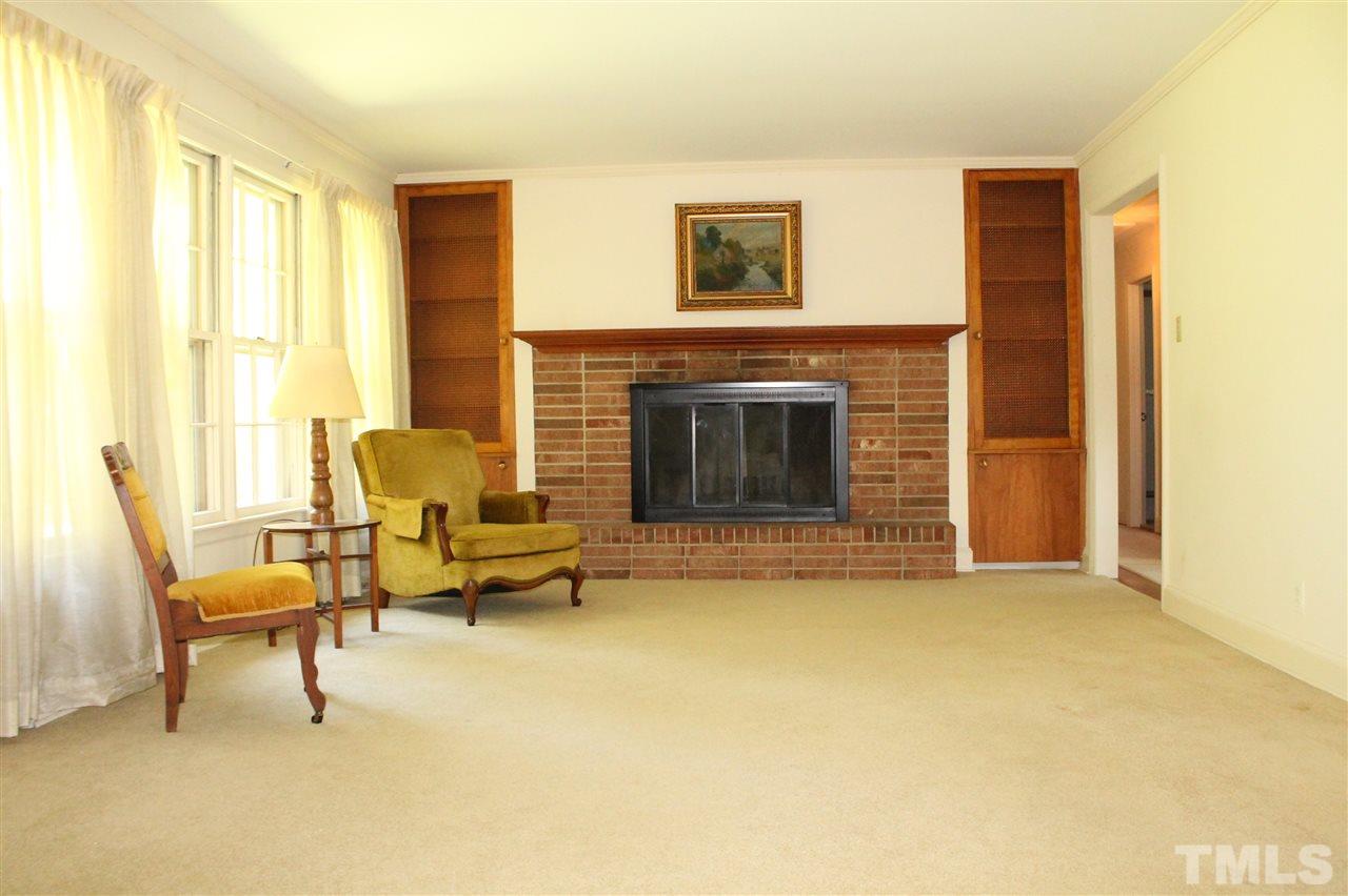 2624 Winton Road Durham, NC 27707 - Photo 4 of 25 What a great room for family gatherings or entertaining. Enjoy the wood burning fireplace surrounded by the custom cabinets.