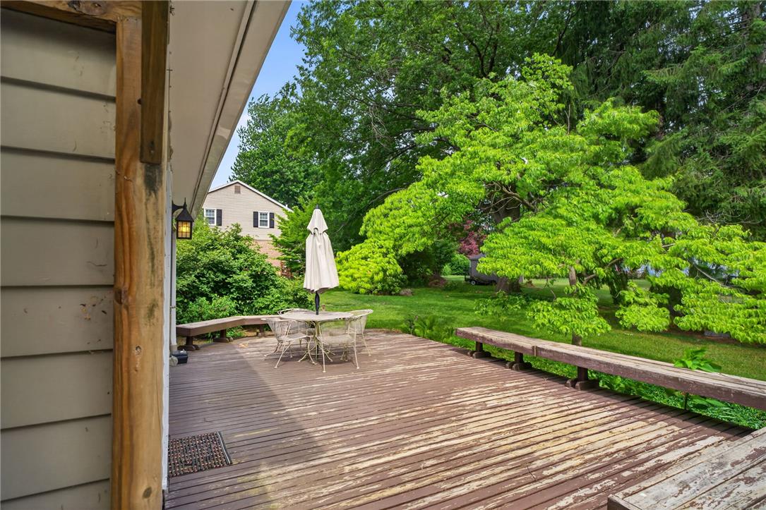765 East Macada Road Bethlehem, PA 18017 - Photo 9 of 46 A spacious wooden deck provides ample outdoor living space, overlooking a verdant lawn.