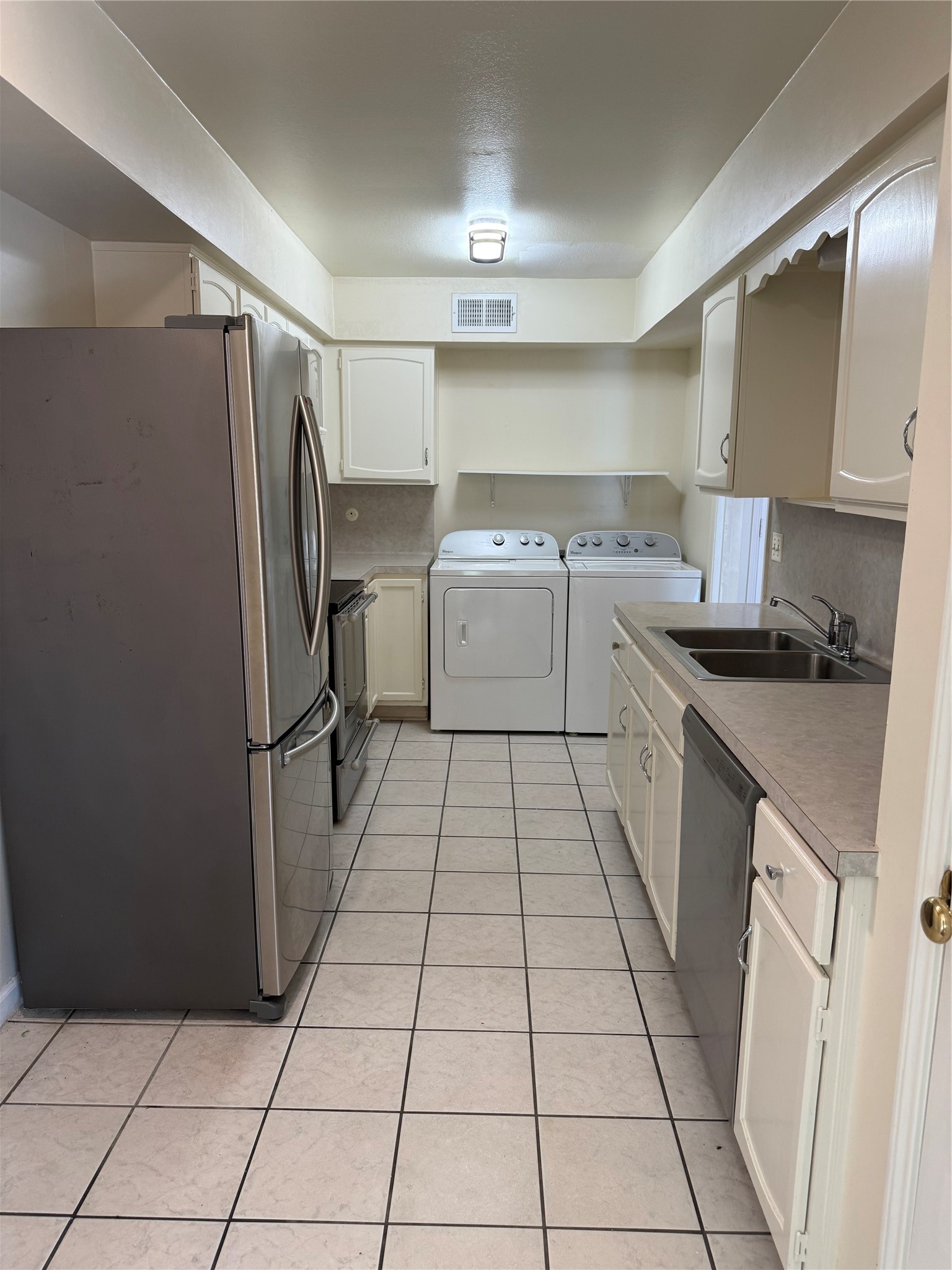 357 North Post Oak Lane, Unit 207 Houston, TX 77024 - Photo 13 of 25 a kitchen with a refrigerator sink and cabinets