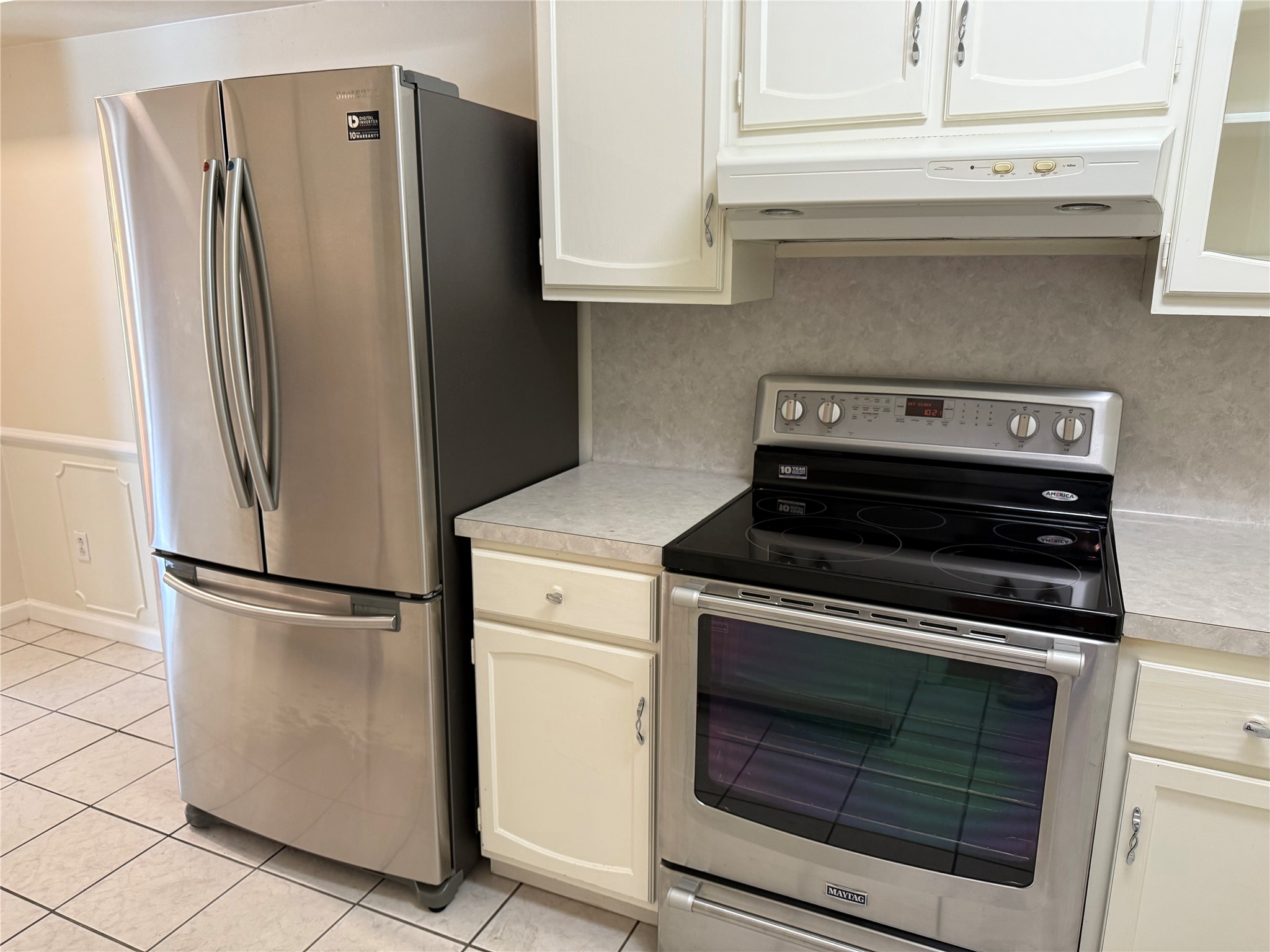 357 North Post Oak Lane, Unit 207 Houston, TX 77024 - Photo 14 of 25 a kitchen with granite countertop white cabinets and stainless steel appliances