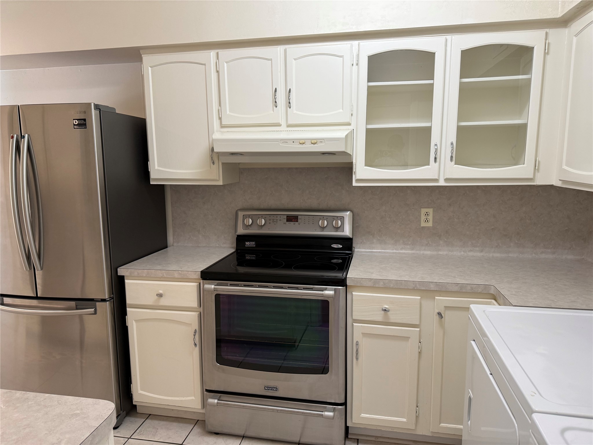357 North Post Oak Lane, Unit 207 Houston, TX 77024 - Photo 15 of 25 a kitchen with stainless steel appliances white cabinets and a refrigerator