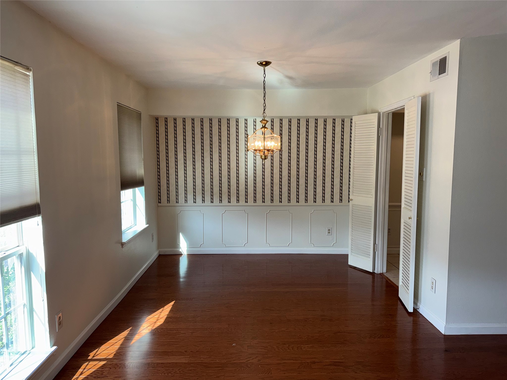 357 North Post Oak Lane, Unit 207 Houston, TX 77024 - Photo 19 of 25 a view of an empty room with wooden floor and a window